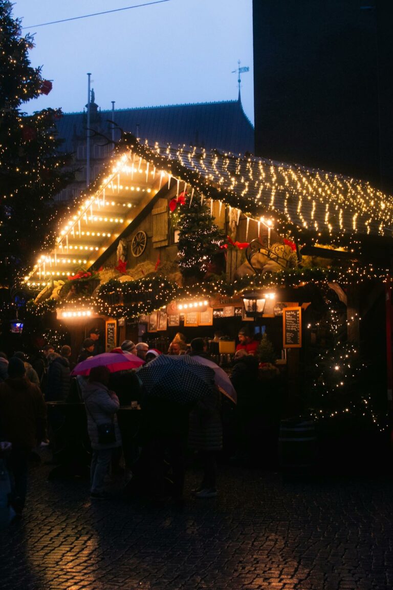 A festive Christmas market stall in Bremen adorned with twinkling lights and holiday decorations.